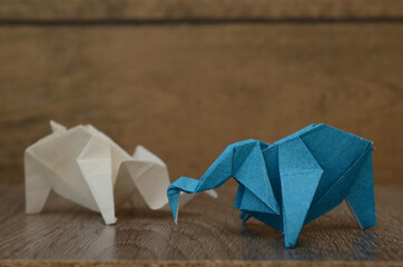two blue and white origami elephants