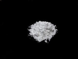 Cocaine drug powder pile on black background