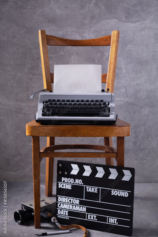 Sticker vintage typewriter at wooden old shelf near wall background surface