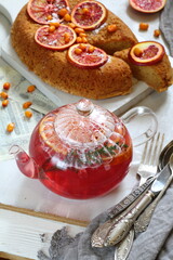 Sponge cake with red oranges on gray background