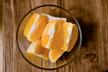 top shot of sliced orange fruit on wooden table