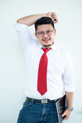 Expert in digital technologies. Cheerful young man in formal wear working on digital tablet and smiling while standing isolated on white background