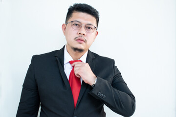 Handsome young business man wear glasses red tie in a suit and west.