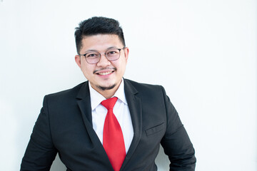 Handsome young business man wear glasses red tie in a suit and west.