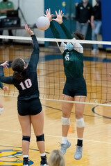 Young athletic girl competing in a volleyball game