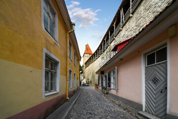 One of the city gate towers rises above the medieval wall surrounding the ancient city of Tallinn, Estonia.