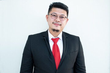 Handsome young business man wear glasses red tie in a suit and west.