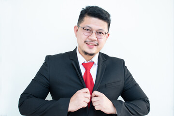 Handsome young business man wear glasses red tie in a suit and west.
