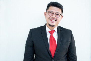 Handsome young business man wear glasses red tie in a suit and west.