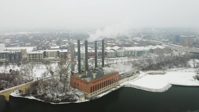 Steam Power Plant in Winter Along Mississippi River. Slow Dolly In, Aerial View