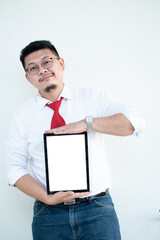 Expert in digital technologies. Cheerful young man in formal wear working on digital tablet and smiling while standing isolated on white background