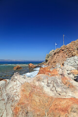Fototapeta premium Volcanic soil at the coast of Eftalou, in Lesvos island, Aegean Sea, Greece, Europe. Lesvos is an island created of volcanic eruptions millions of years ago and volcanic rocks and almost everywhere 