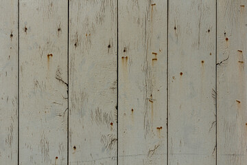 Fototapeta premium Texture of rural stained exterior vertical oak planks of country shed. Old dirty rough siding of gnarled surface wooden paneling. Rustic veined facing lumber fence of hard boards for 3D style design