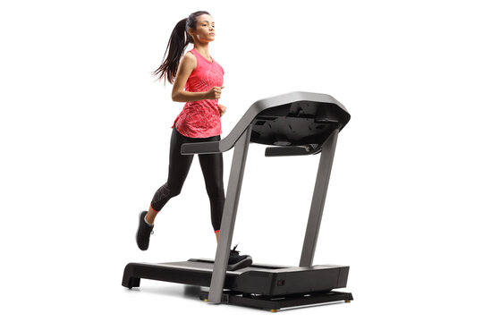 Mixed race young woman in sportswear running on a treadmill