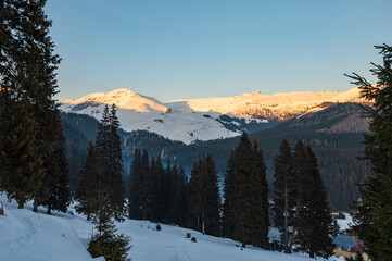 Evening sun on the snowy peaks in Romanian mountains