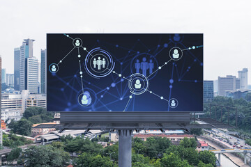 Glowing Social media icons on road billboard over panoramic city view of Kuala Lumpur, Malaysia, Asia. The concept of networking and establishing new connections between people and businesses in KL.