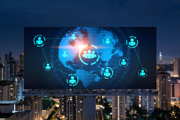 World planet Earth map hologram and social media icons on billboard over night panoramic city view of Kuala Lumpur, Malaysia, Asia. Networking and establishing new connections between people. Globe