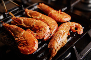 Grilled large shrimps with lemon and spices on the grill pan