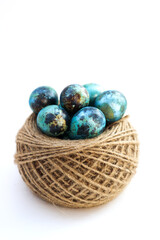 Easter colored eggs in a nest on a white background