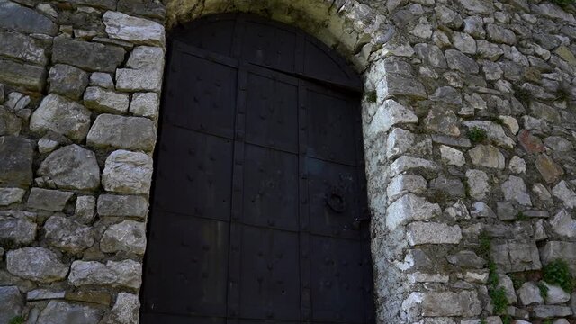 Iron heavy locked door of stone building located inside medieval castle