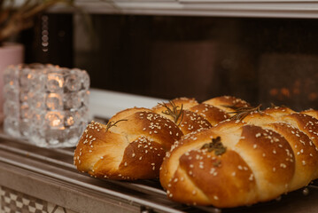 Candles and handmade traditional challah, tasty bread for Shabbat.