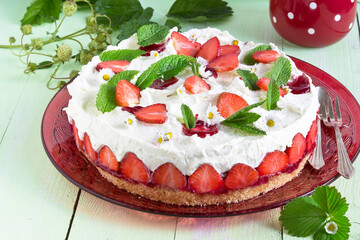 Strawberry cake with edible flowers and mint leaves