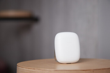 the case for wireless headphones is on the table the closed cover of the headphones the background is blurred