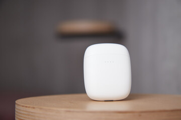 the case for wireless headphones is on the table the closed cover of the headphones the background is blurred