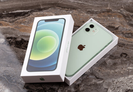 Rostov-on-Don, Russia - November  2020. iPhone 12 is green on a marble surface. New smartphone from Apple company close-up.
