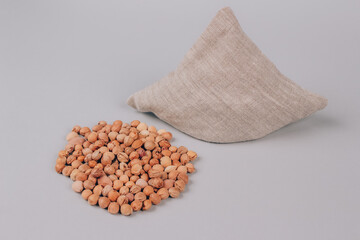 Cherry stone pillow, heating pad, cherry pit filled pillow - natural heat or cool pack. Alternative medicine and therapy, pit sack for spa massage, chiropractic and home health. Copy space, mockup © Iryna Mylinska