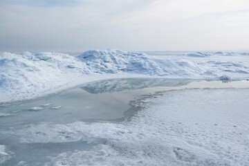 Beautiful scenery of frozen sea in delicate light. Baltic Sea, Puck Bay, Poland