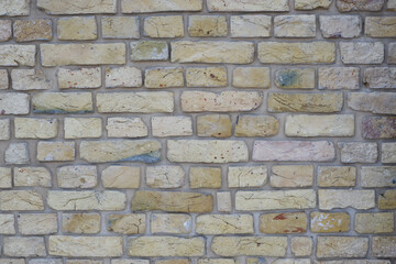 Peeled old brick wall. Brick yellow background.