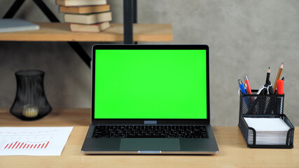 Close up modern laptop computer display mock up chroma key green screen standing on table working office business workplace. Online remote distance learning video conference call webcam education chat