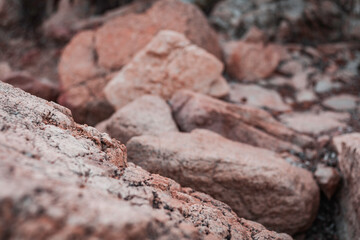 Fototapeta premium Beautiful sunset seascape in Italy, Sardinia island. Red and pink rocks, wind erosion, geology stratification, air oxydation. Teal and orange lighting, 