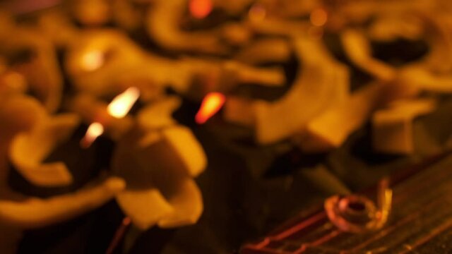 Coconut chips on a dark table close-up. Black background, slow motion.