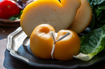 Cheese collection, Italian cheeses provolone, caciocavallo, scamorza made from sheep or cow milk in South Italy, white and yellow smoked.