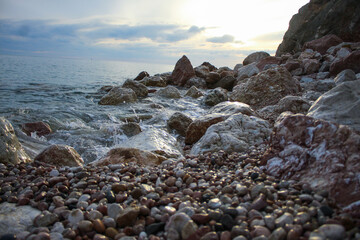 stone beach in the rock. Black Sea. sunset.