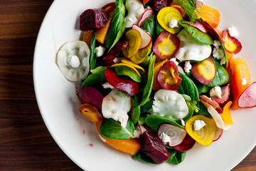 Beet salad. Classic Italian salad with beets, mozzarella, spinach, arugula, Parmesan cheese, olive oil, lemon juice, salt and pepper. A Fine dining restaurant classic.
