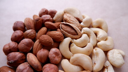 Different nuts are all together. Almonds, hazelnuts, cashews, walnuts. Mix of nuts. Healthy eating.