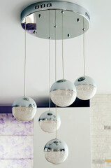 Beautiful modern ball shaped chandelier hanging from the ceiling.