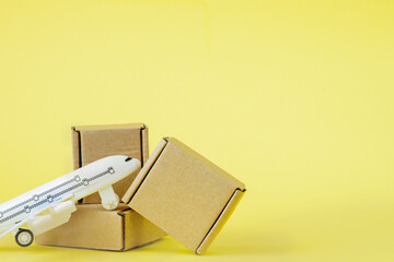 Airplane and stack of cardboard boxes. concept of air cargo and parcels, airmail. Fast delivery of goods and products. Cargo aircraft. Logistics, connection to hard-to-reach places. Banner, copy space