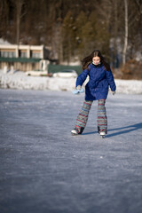 Child ice skating on frozen canal 