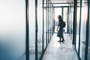 Fototapeta na wymiar Business woman leaving office.Businesswoman walking in office corridor.