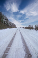 Fototapeta na wymiar a road passing the edge of the forest.winter in the russian federation