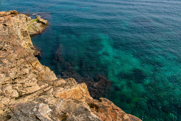 Fototapeta na wymiar Sliema rocky beach in Malta. Beautiful blue mediterranean sea. Selective focus. 