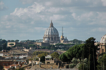 Fototapeta na wymiar View over the rooftops of Rome with the St. Peter's Basilica in the middle