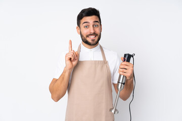 Man using hand blender isolated on white background pointing with the index finger a great idea