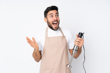 Man using hand blender isolated on white background with surprise facial expression