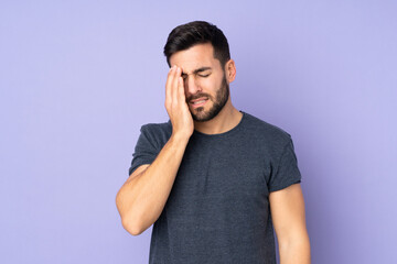 Caucasian handsome man with headache over isolated purple background
