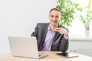 Handsome businessman working with laptop in office